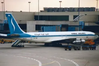 A Somali Airlines Boeing 707-338C parked at an airport gate.
