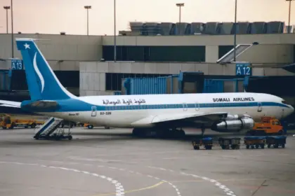 A Somali Airlines Boeing 707-338C parked at an airport gate.