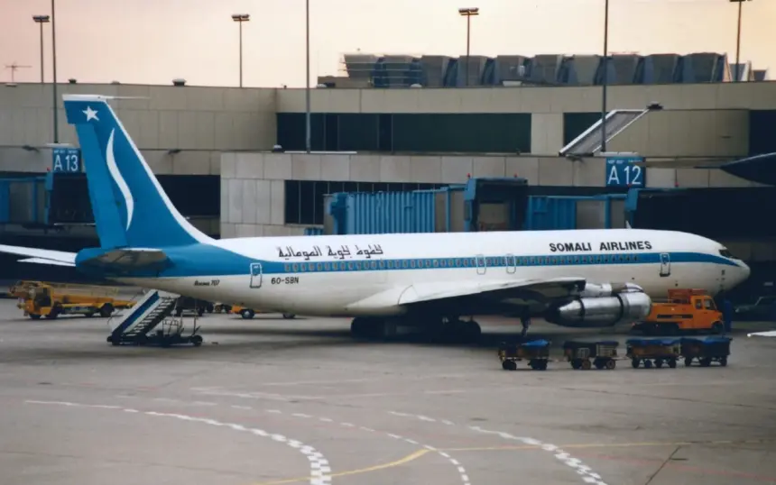 A Somali Airlines Boeing 707-338C parked at an airport gate.