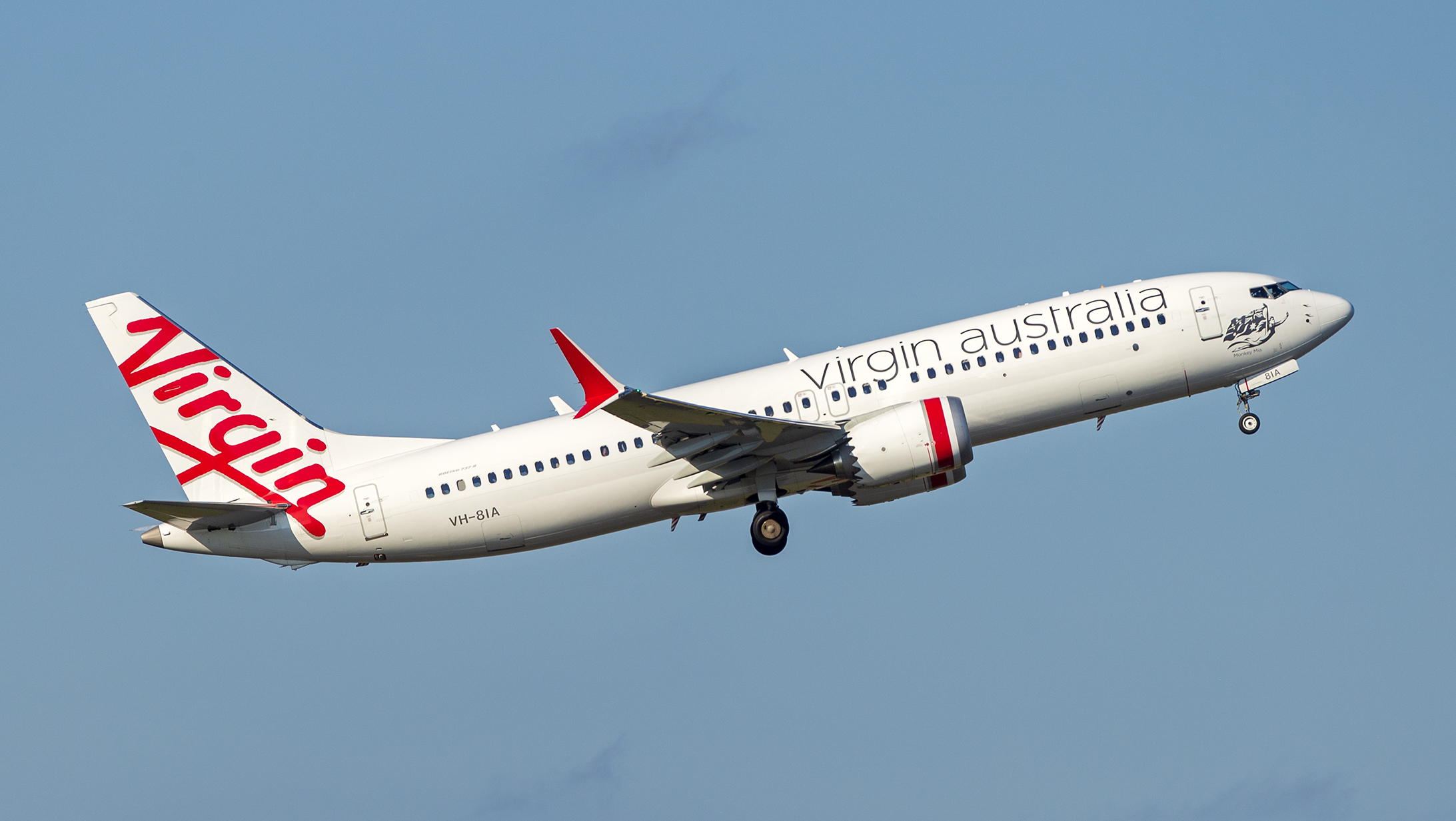 Virgin Australia's Boeing 737 MAX 8 (registration VH-8IA) in the sky during take off with its landing gear still extended.