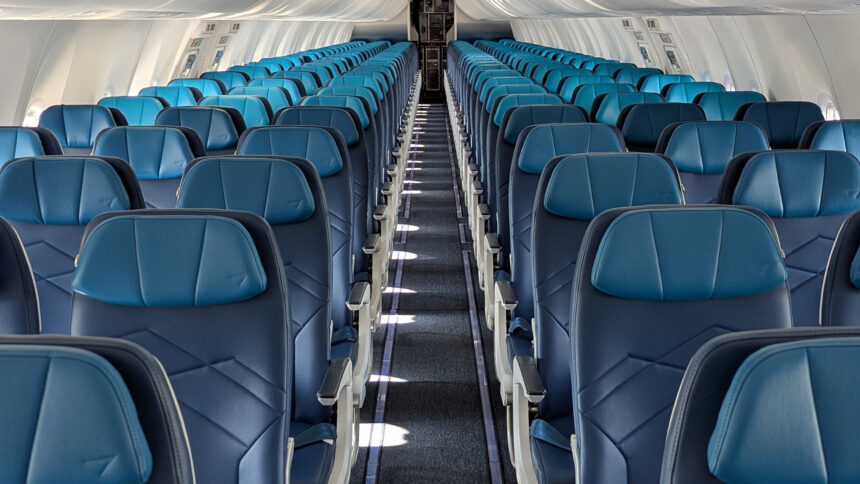 An image of WestJet's narrowbody cabin refresh with the iconic teal and navy blue seats.
