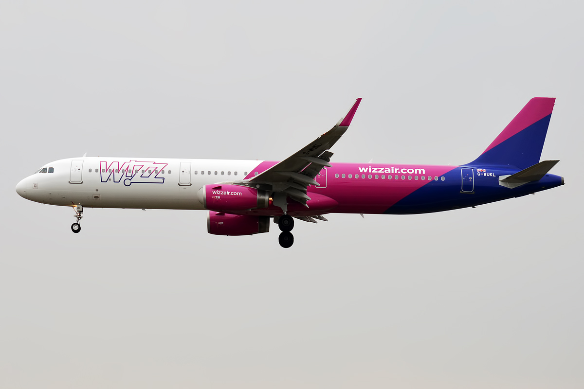 A Wizz Air Airbus A321-231 aircraft on its left-hand side