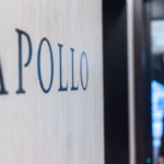 The Apollo Global Management logo engraved into a grey wall, with a figure blurred in the background.
