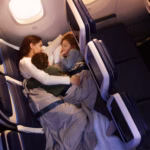 Family of three – mother and two children – lying in United Airlines' Relax Row