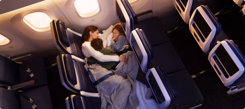 Family of three – mother and two children – lying in United Airlines' Relax Row