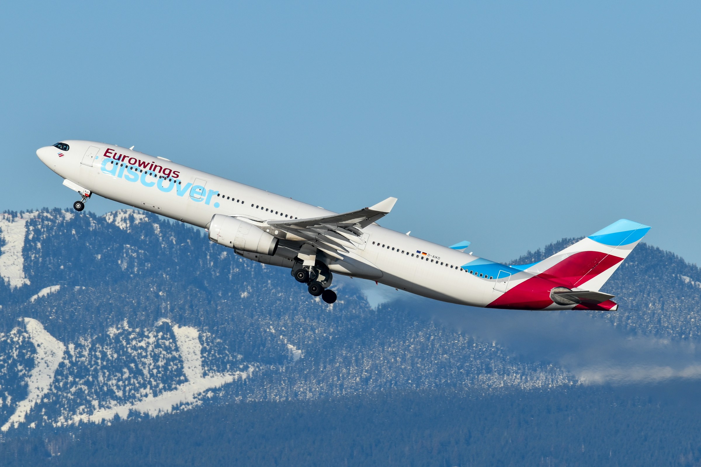 Discover Airlines flying among mountain range