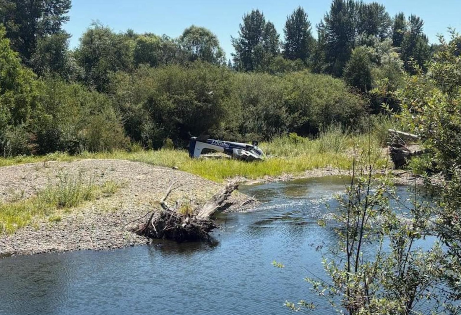 The crashed aircraft spotted from a distance across the a river.