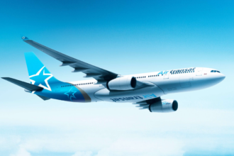 Image shows Air Transat aircraft flying in a light blue sky