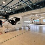 A Beta Technologies aircraft on the ground indoors.