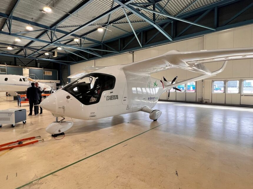 A Beta Technologies aircraft on the ground indoors.