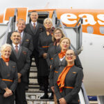 Image show eight easyJet cabin crew on the boarding steps to an easyJet aircraft