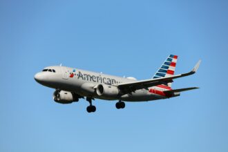 American Airlines mid-flight with blue sky in the backgrouund