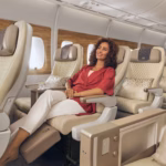 Photograph depicting a lady relaxing in Emirates Premium Economy class