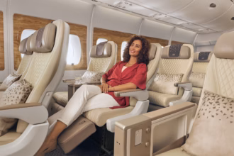 Photograph depicting a lady relaxing in Emirates Premium Economy class