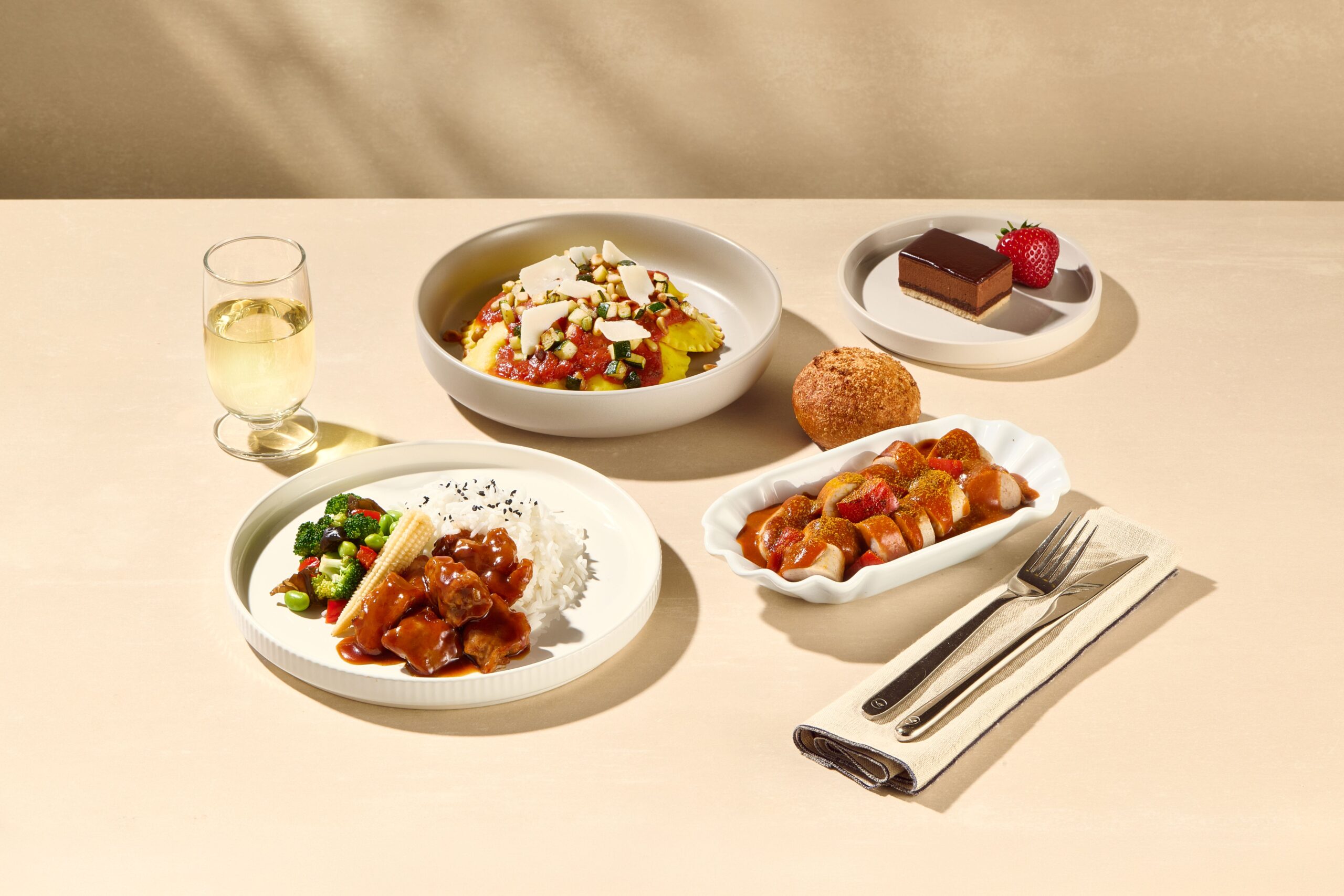 Photograph depicting Lufthansa's onboard delights hot meal ensemble, showcasing some of Lufthansa's specialty cuisine.