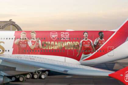 Photograph depicting exterior of Emirates aircraft on the runway emblazoned with Arsenal livery
