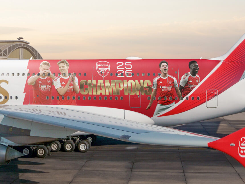 Photograph depicting exterior of Emirates aircraft on the runway emblazoned with Arsenal livery