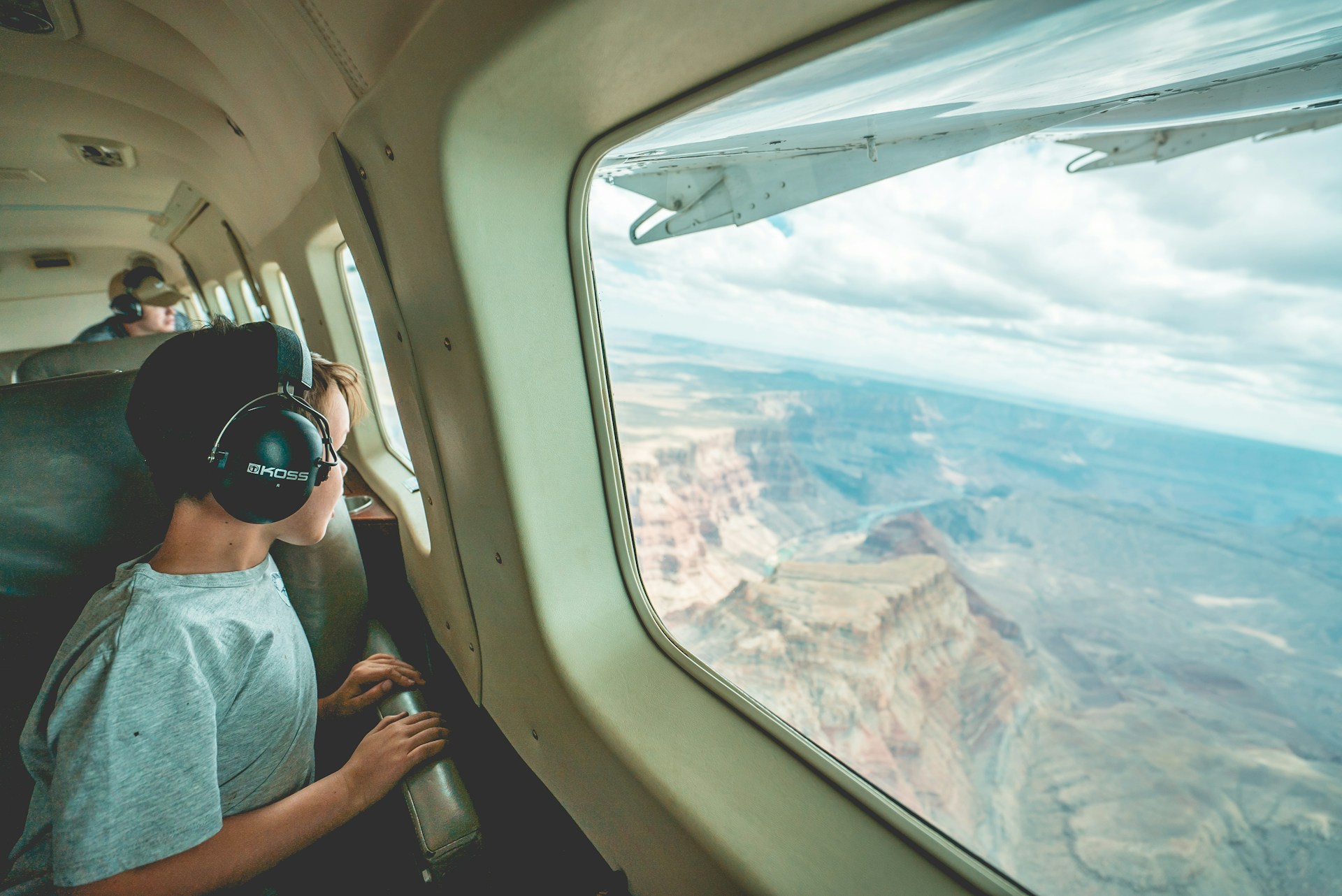 a boy looking out the window mid-air