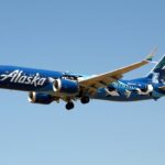 Alaska Airlines' Boeing 737-9 MAX in the air with its landing gear extended.
