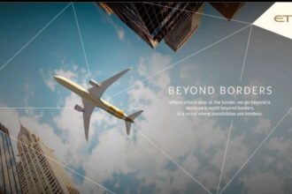 Campaign promotional image featuring an under view of an Etihad Airways aircraft in the sky and two skyscrapers near it.
