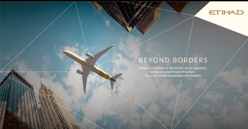 Campaign promotional image featuring an under view of an Etihad Airways aircraft in the sky and two skyscrapers near it.