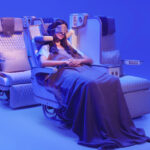 The photograph shows a customer relaxing in Emirates’ new Premium Economy seat, featuring the globally acclaimed U-Dream headrest for enhanced neck and head support