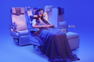 The photograph shows a customer relaxing in Emirates’ new Premium Economy seat, featuring the globally acclaimed U-Dream headrest for enhanced neck and head support