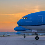 Photograph depicting the front of KLM aircraft including the cockpit and wheels on the runway.