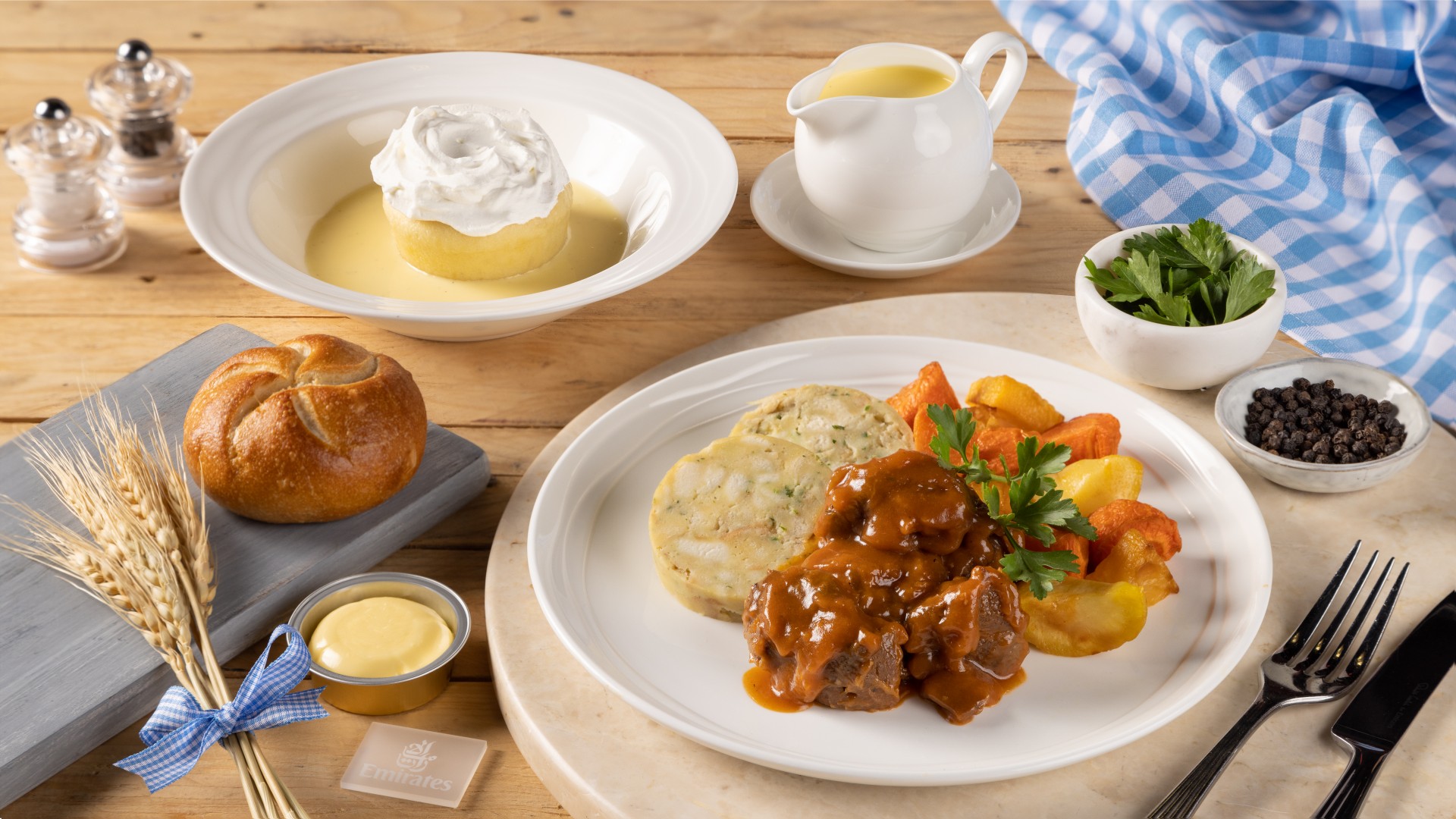 Photograph depicting cooked meals with meat and potatoes and a spread of other foods as part of Emirates Oktoberfest.