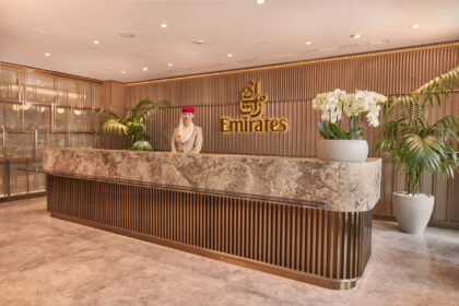 Photograph depicting the entrance to the Emirates lounge at Manchester airport staffed by Emirates worker.