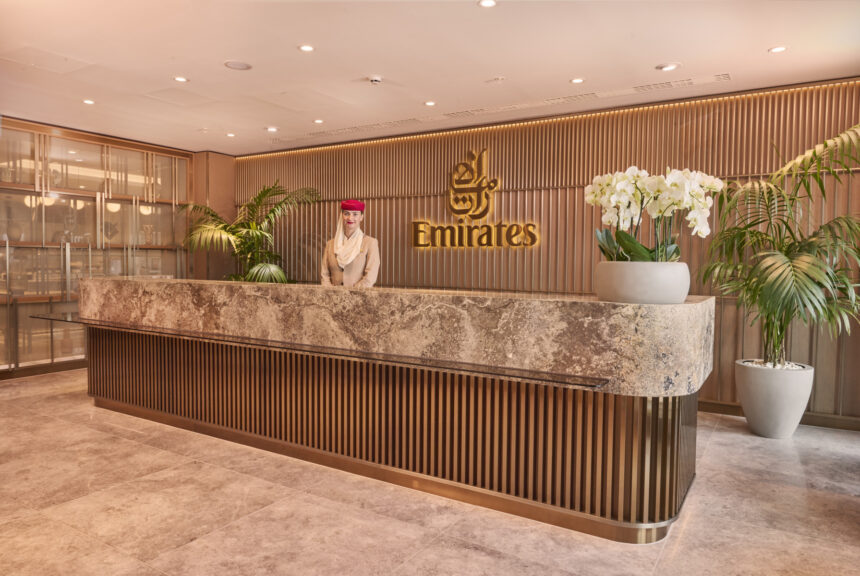 Photograph depicting the entrance to the Emirates lounge at Manchester airport staffed by Emirates worker.
