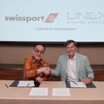Representatives from Swissport and UNEX Aviation Services shaking hands in signing a strategis partnership