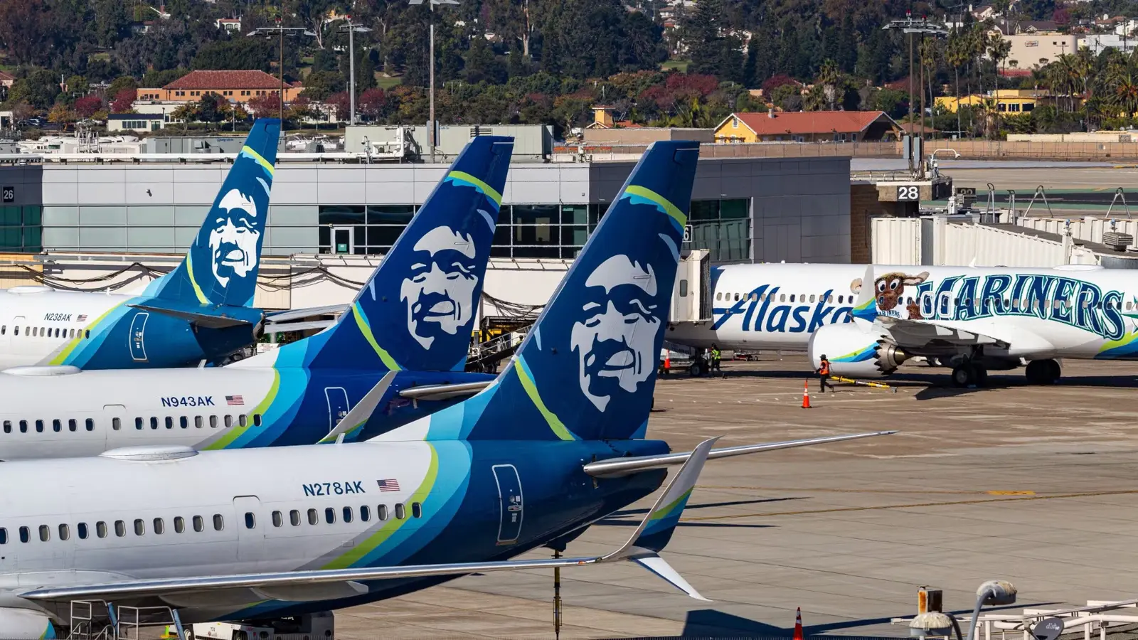 The tail of three Alaska Airlines aircrafts.