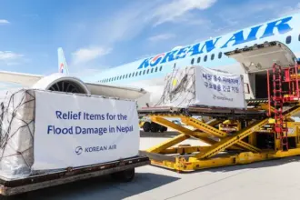 Image shows a Korean Air flight being loaded with emergency relief supplies for Nepal flood victims during the daytime