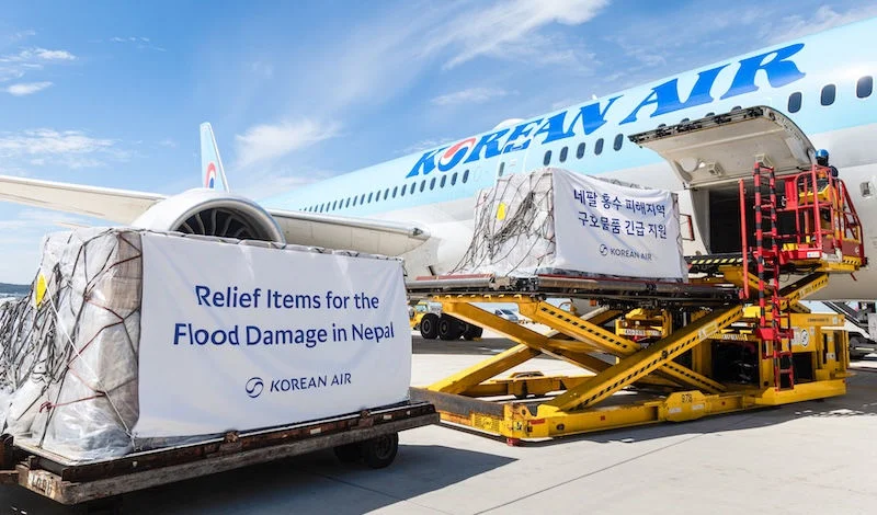 Image shows a Korean Air flight being loaded with emergency relief supplies for Nepal flood victims during the daytime
