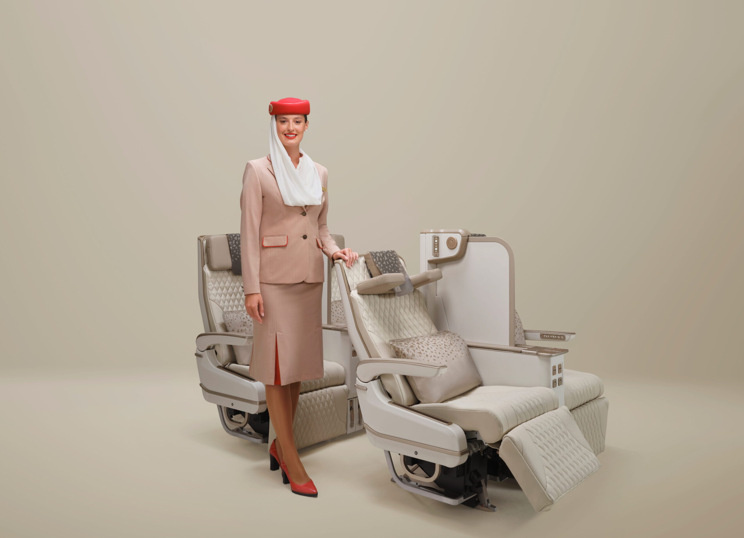 This photograph depicts Emirates’ new electrically powered Premium Economy seat alongside Emirates cabin crew.