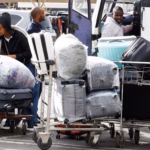 Carts of luggage near a bus after stranded travelers' flights were canceled due to a strike at Jomo Kenyatta International Airport in Nairobi, Kenya.