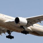 Etihad Airways' Airbus A350-1041 in the air with its landing gear extended.