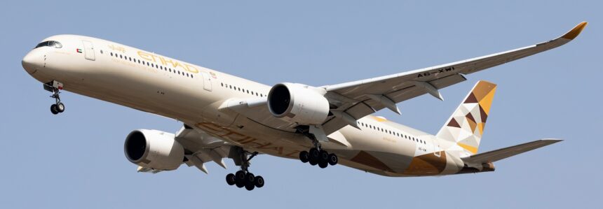Etihad Airways' Airbus A350-1041 in the air with its landing gear extended.