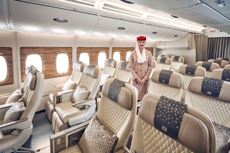 Photograph depicting an Emirates flight attendant presenting the Emirates Premium Economy class onboard the Airbus A380.