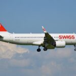 A SWISS Airbus A320neo approaching Zurich Airport with its landing gear lowered
