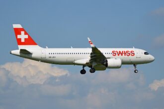 A SWISS Airbus A320neo approaching Zurich Airport with its landing gear lowered
