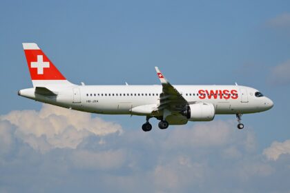 A SWISS Airbus A320neo approaching Zurich Airport with its landing gear lowered