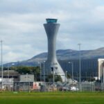 Airside at Edinburgh Airport with buildings and other airport infrastructure in the background.