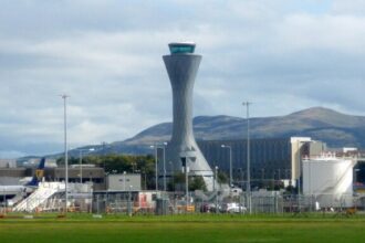 Airside at Edinburgh Airport with buildings and other airport infrastructure in the background.