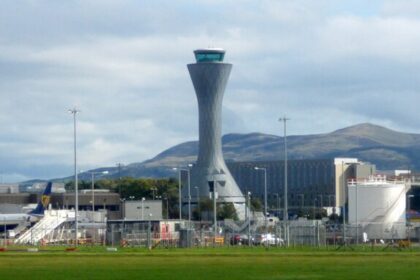 Airside at Edinburgh Airport with buildings and other airport infrastructure in the background.