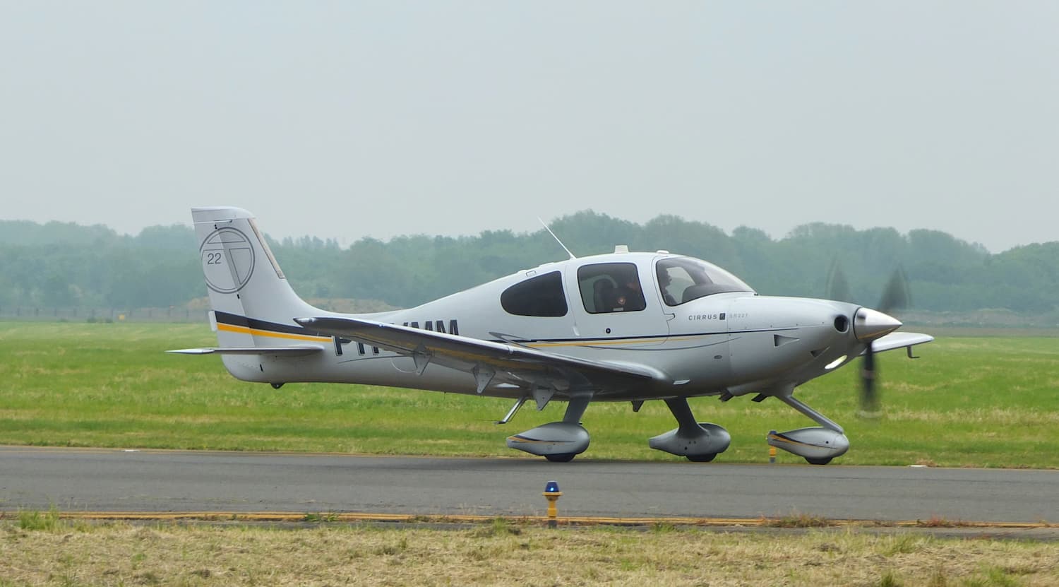 Image shows a Cirrus SR22T on a runway