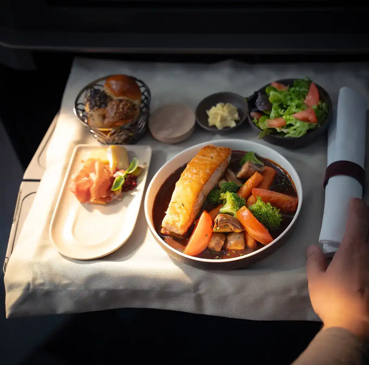 A complimentary meal created by Álvaro Clavijo, chef and founder of El Chato in Bogotá. Inspired by Latin America, the dish shows a blend of different vegetables along with salmon, butter and bread. The dish looks colourful and looks intensely flavourful.