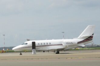 A Cessna Citation Latitude sitting on a runway, pictured from the side