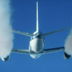 Photograph depicting Douglas DC 8 producing contrails from engines at biofuels tests.